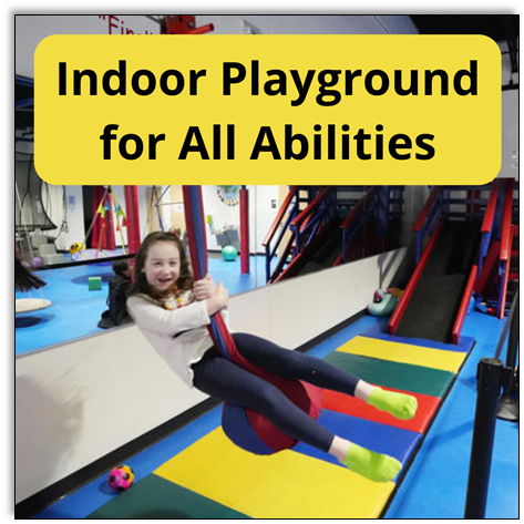 Indoor Playground for All Abilities. Child swings over brightly colored play mats